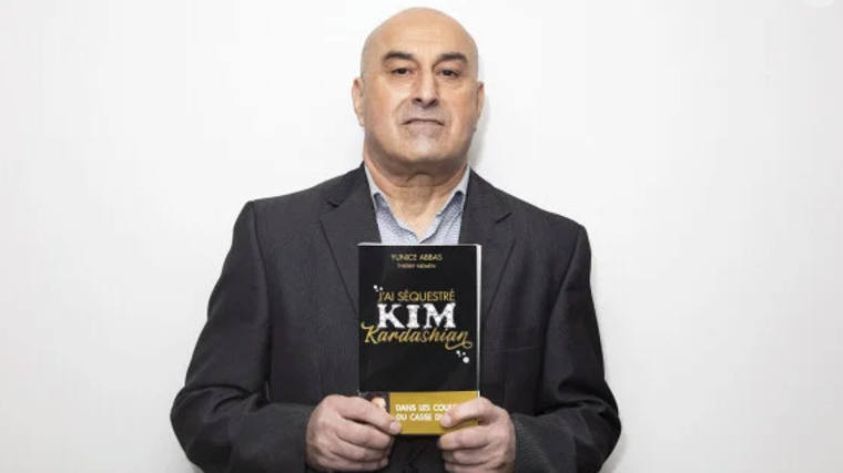 Yunice Abbas with his book 'I kidnap Kim Kardashian'.