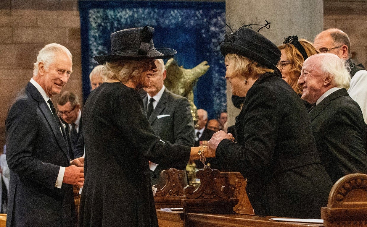 El Rey Carlos III de Gran Bretaña mira mientras la Reina consorte habla con Sabina Coyne y el presidente irlandés Michael D. Higgins tras un servicio de reflexión en la catedral de Santa Ana en Belfast