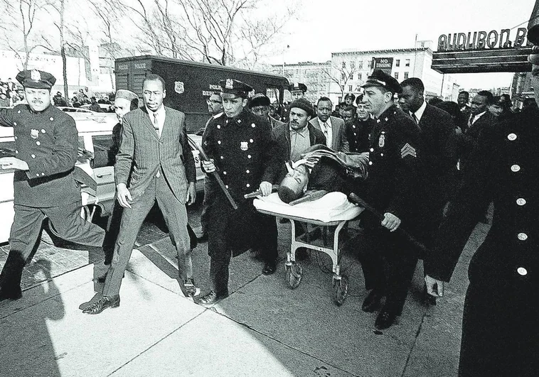 Several people pushed Malcolm X's stretcher out of the Audubon Ballroom, where the activist was shot
