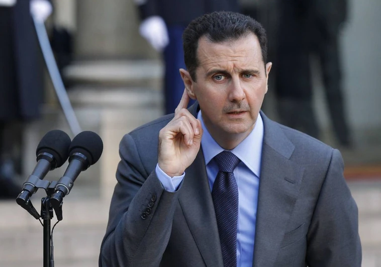 Syrian President Bashar al-Assad responds to reporters during a 2010 press conference at the Elysee Palace