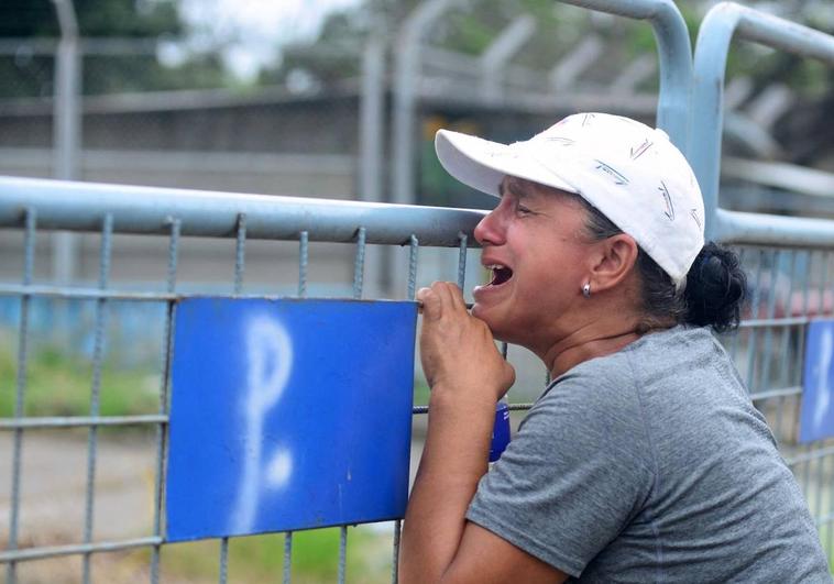 A woman cries outside Guayas 1 prison after clashes between inmates in Guayaquil, Ecuador