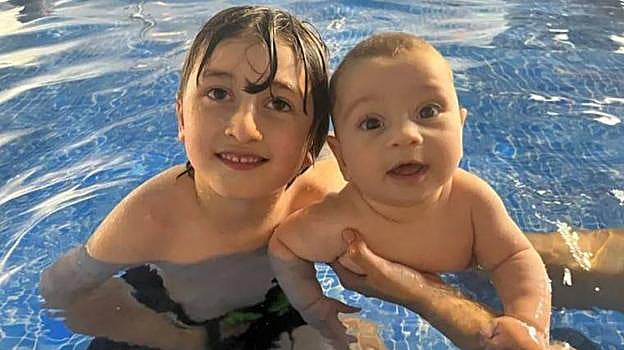 Robin, de 5 años, junto a su hermano, de seis meses, minutos antes de morir ahogado