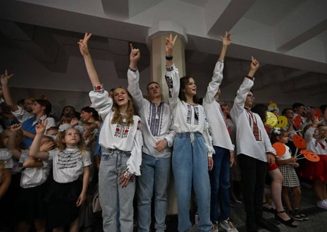 Imagen secundaria 1 - Los alumnos asisten a una ceremonia celebrada en una estación de metro para marcar el comienzo del nuevo año escolar , conocido como el «Día del Conocimiento» en Járkov, el 1 de septiembre de 2023,