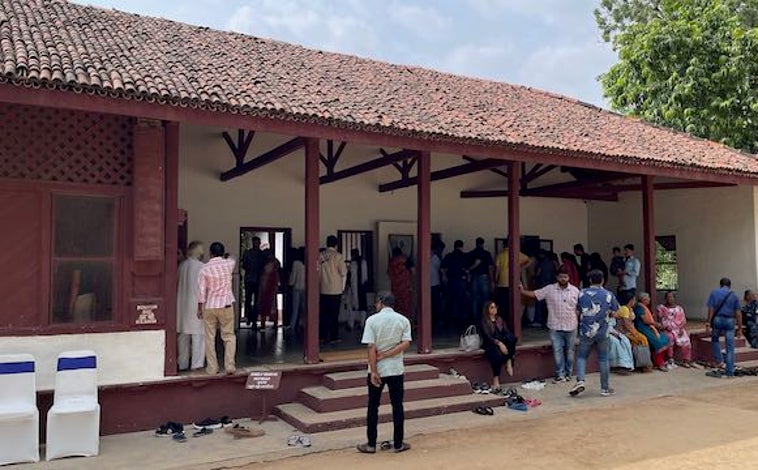 Imagen principal - A orillas del río Sabarmati en la ciudad de Ahmedabad, en el estado occidental de Gujarat, se levanta esta casa de dos pabellones, pero muy humilde y sencilla, donde Gandhi se instaló en 1917, dos años después de volver de Sudáfrica (imagen superior) para dirigir el movimiento por la independencia de la India. Este 'ashram', mezcla de cooperativa y monasterio hinduista, todavía conserva la famosa rueca con la que Gandhi se pasaba horas hilando (arriba a la izquierda), símbolo de su dedicación y constancia. Como padre de la India, su figura es venerada por los más de 3.000 turistas que cada día visitan el lugar (arriba a la derecha).