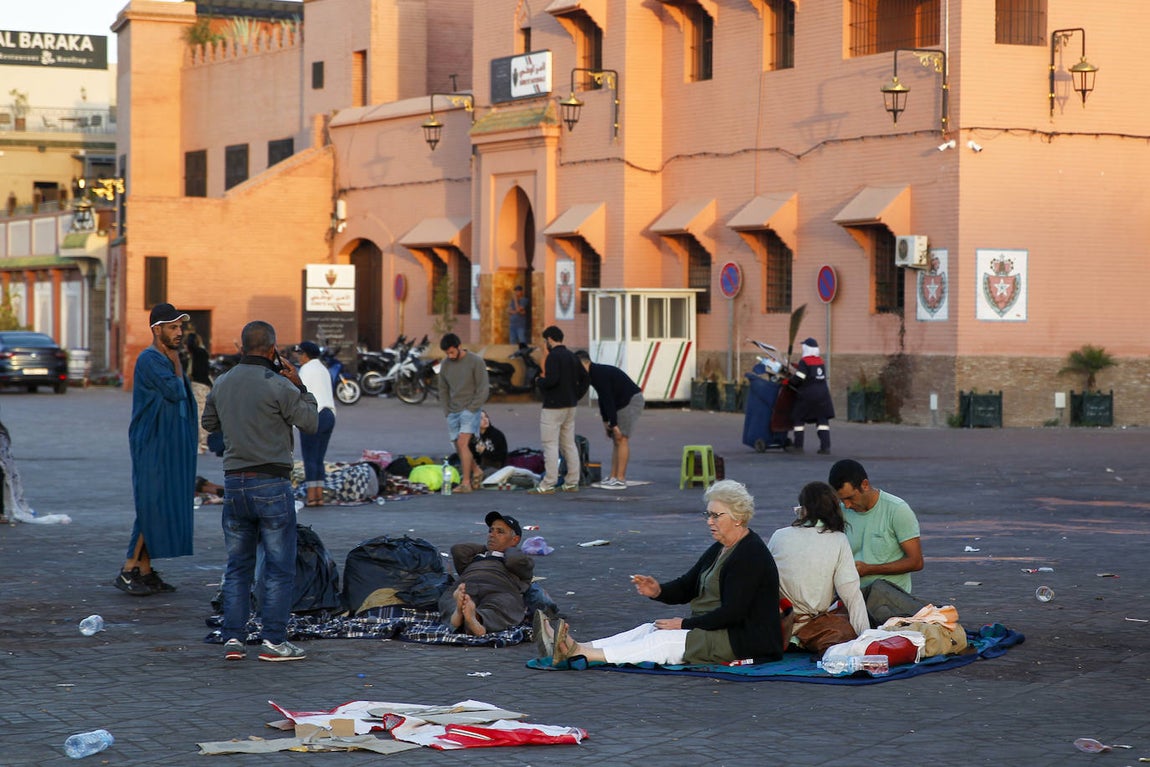 Varias personas descansan en medio de una calle de Marrakech a primera hora de este sábado