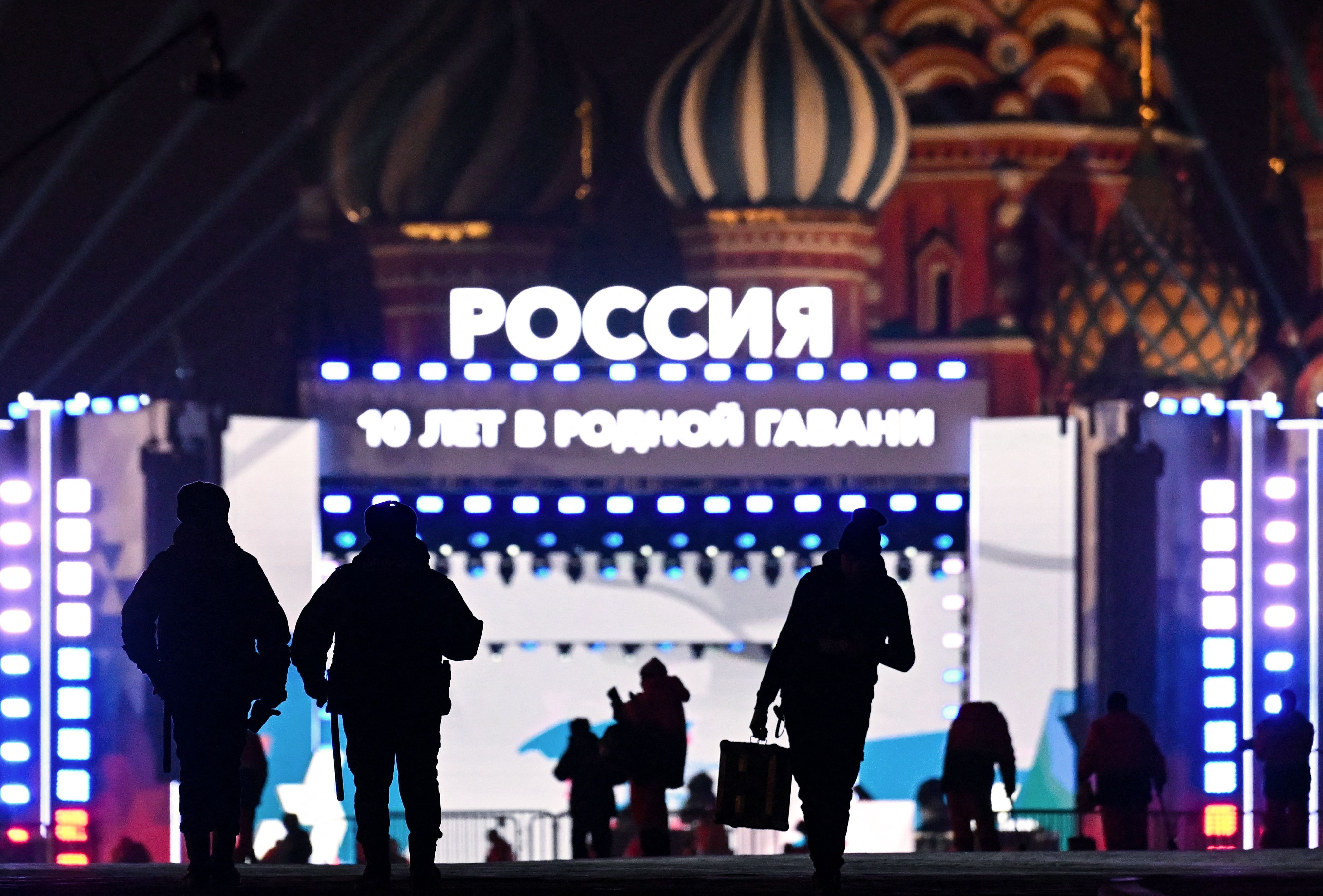 Policías rusos permanecen en  una Plaza Roja de Moscú ya casi vacía tras el acto de Putin.