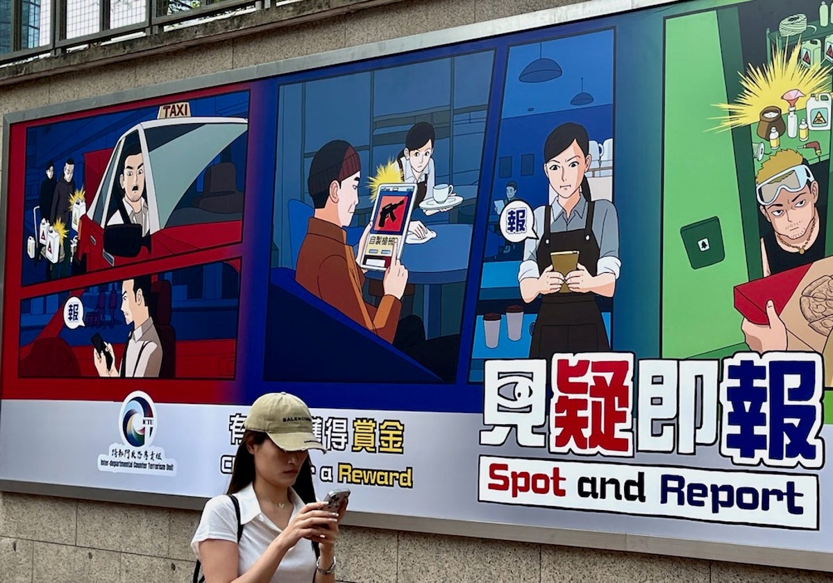 Cartel en la comisaría central de Hong Kong ofreciendo recompensas por 'vigilar y denunciar' actos sospechosos de terrorismo