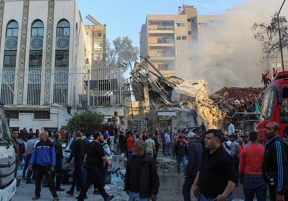 La gente se reúne cerca del edificio del consulado de Irán en Damasco, Siria, dañado por Israel