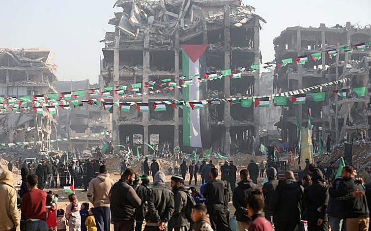 Imagen principal - La multitudes en Yabalia, donde ha sido liberada la soldado israelí; gentío en Jan Yunis con la bandera tailandesa y un fotograma del vídeo de la Yihad donde aparece el abrazo entre los civiles liberados Gadi Moses y Arbel Yehud