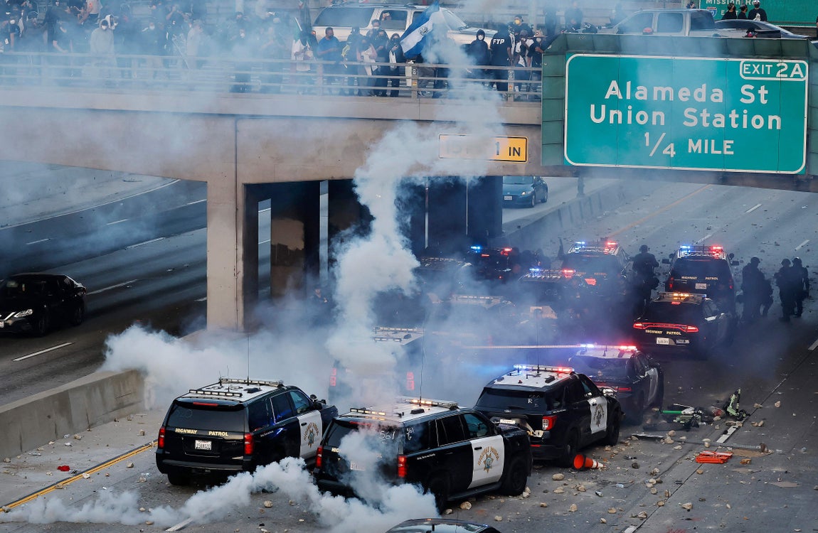Coches de policía son impactados por botes de humo.