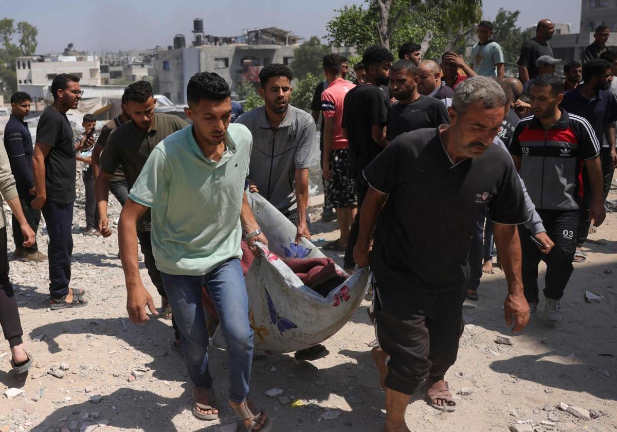 Palestinos sacan a una persona de los escombros tras un ataque israelí.