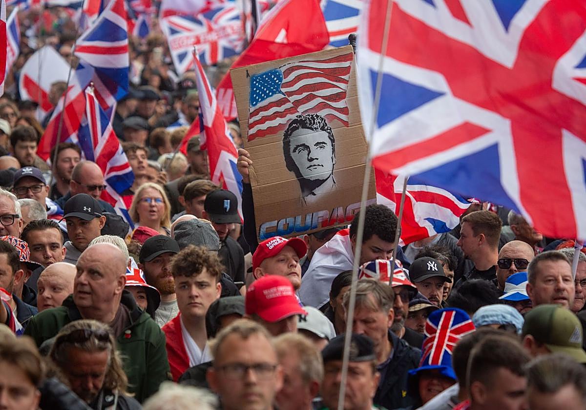 Manifestantes exhiben una pancarta con la cara de Charlie Kirk, asesinado en EE.UU., entre banderas británicas durante una protesta en el centro de Londres