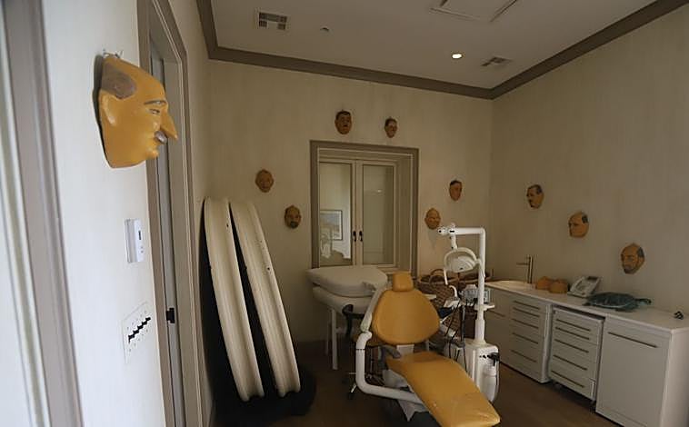 Main image - Consultation with dentist chair, telephone with crossed out contacts, white board with words, some covered