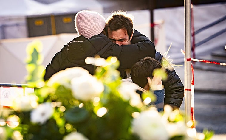 Imagen principal - Un hombre es consolado cerca del local incendiado en el que murieron 40 personas; este mismo jueves se celebró una misa en recuerdo de los fallecidos; a la derecha, el presidente de la Confederación Suiza, Guy Parmelin