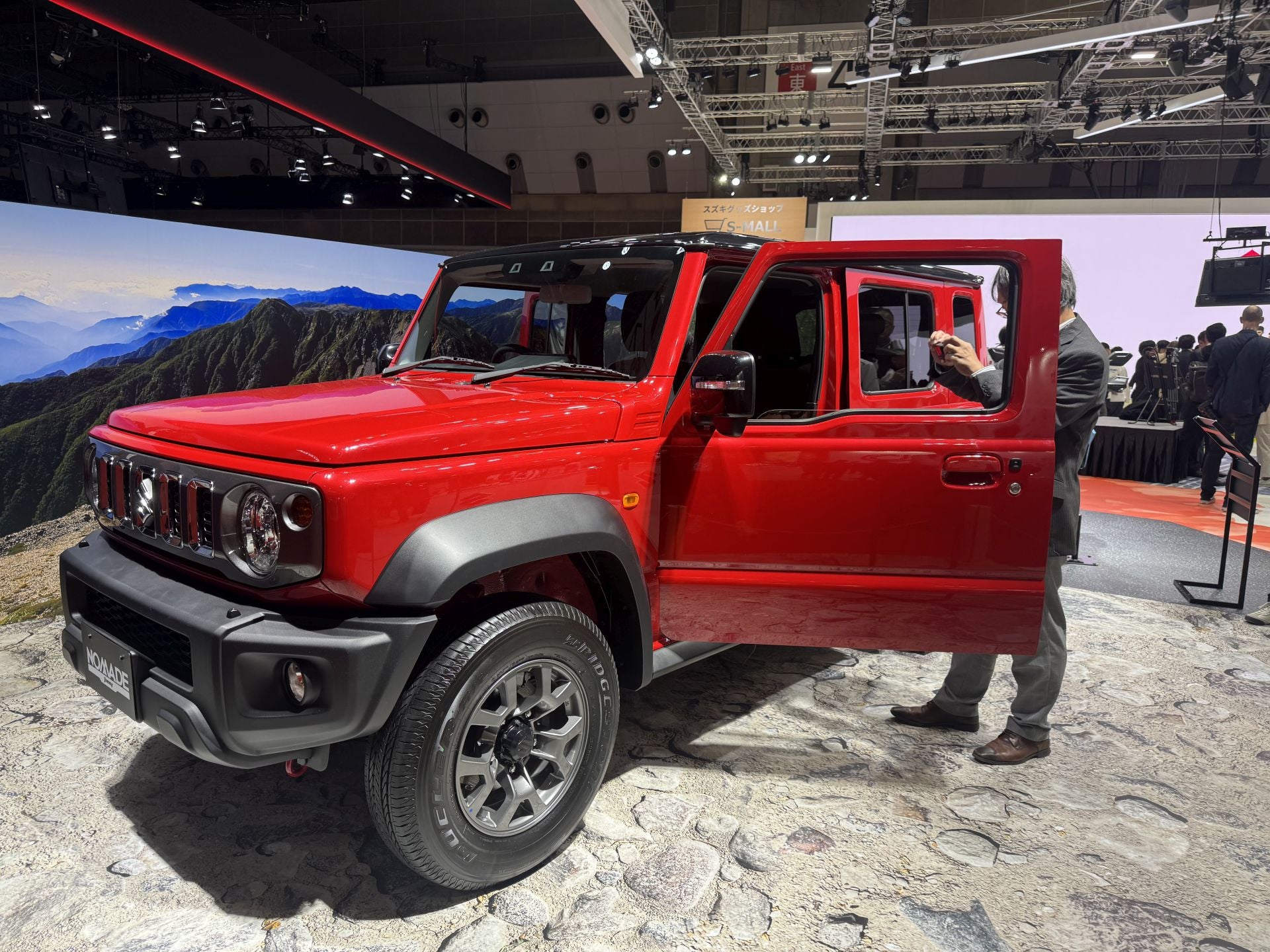 Suzuki muestra una estrategia de movilidad más amplia, no centrada únicamente en automóviles convencionales. Entre sus novedades principales está el prototipo de coche eléctrico ligero para el segmento kei-car: Suzuki Vision e‑Sky cuya producción está prevista para 2026. Exhibe también el scooter eléctrico Suzuki e‑VanVan y del módulo de movilidad «MOQBA 2» (cuatro patas) como parte de su visión integral de fabricante de movilidad, bajo el lema «By Your Side».