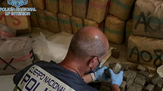 Un policía nacional revisa un alijo de hachís en una imagen de archivo