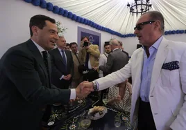 Juanma Moreno y Carlos Herrera en la recepción de la caseta de Cope