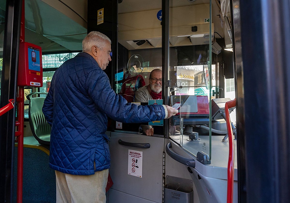 Un usuario de Tussam activa su tarjeta al acceder al interior de una de las líneas de autobús