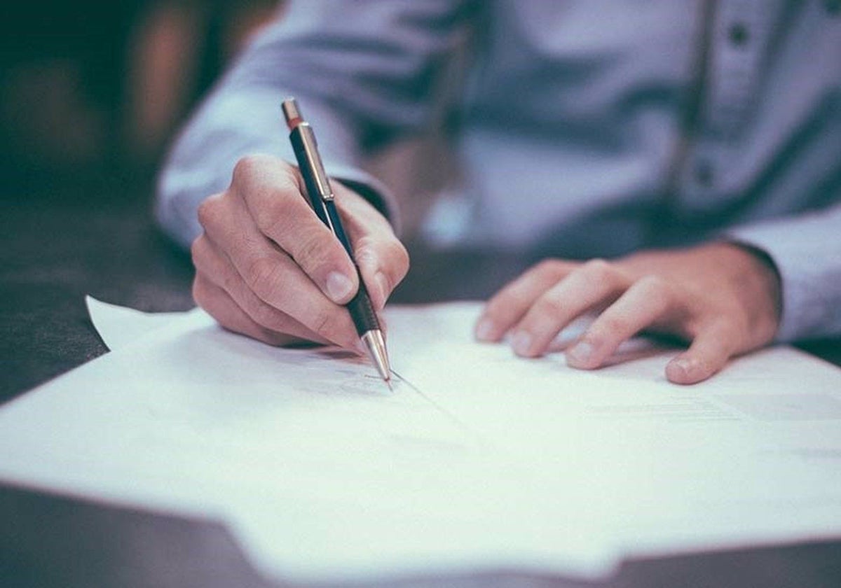 Un empresario firma unos papeles