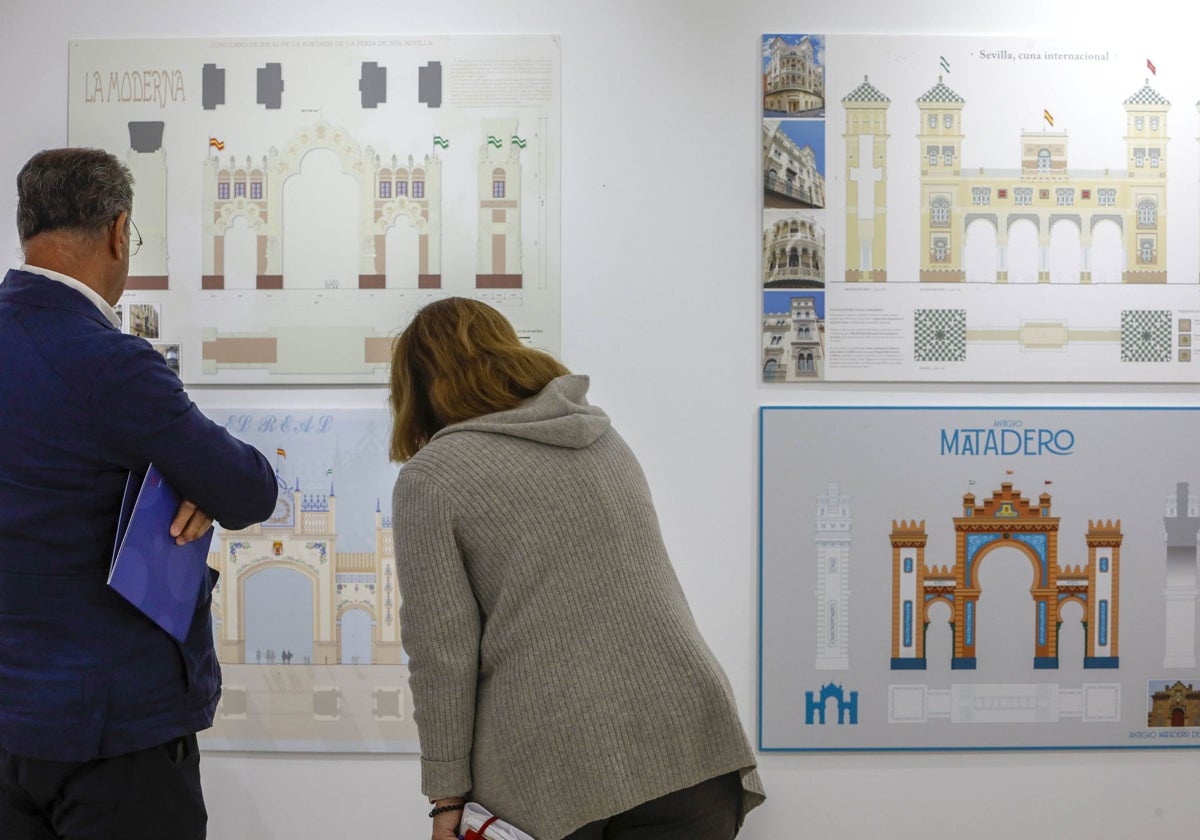 Dos personas miran cuatro de las propuestas presentadas para la portada de la Feria de Abril de Sevilla en 2024