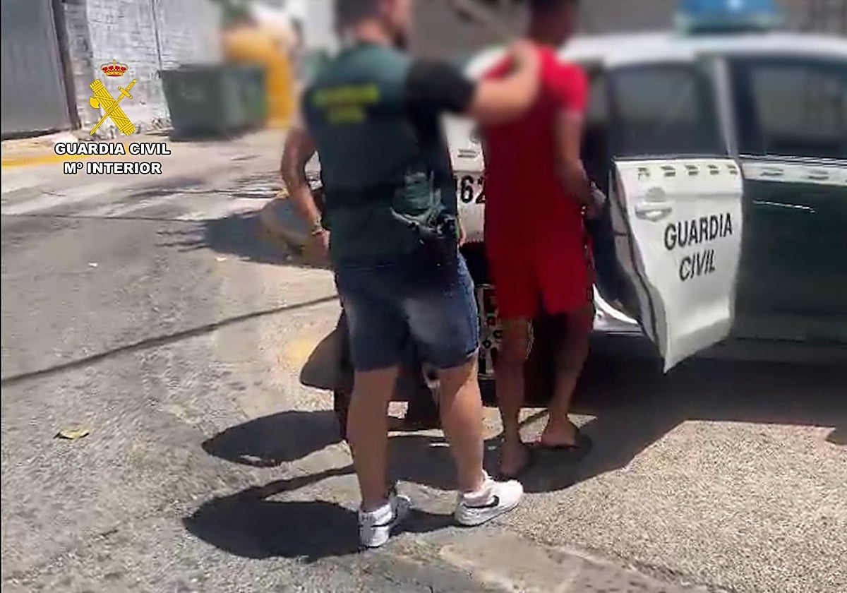 Uno de los detenidos conducido por los agentes