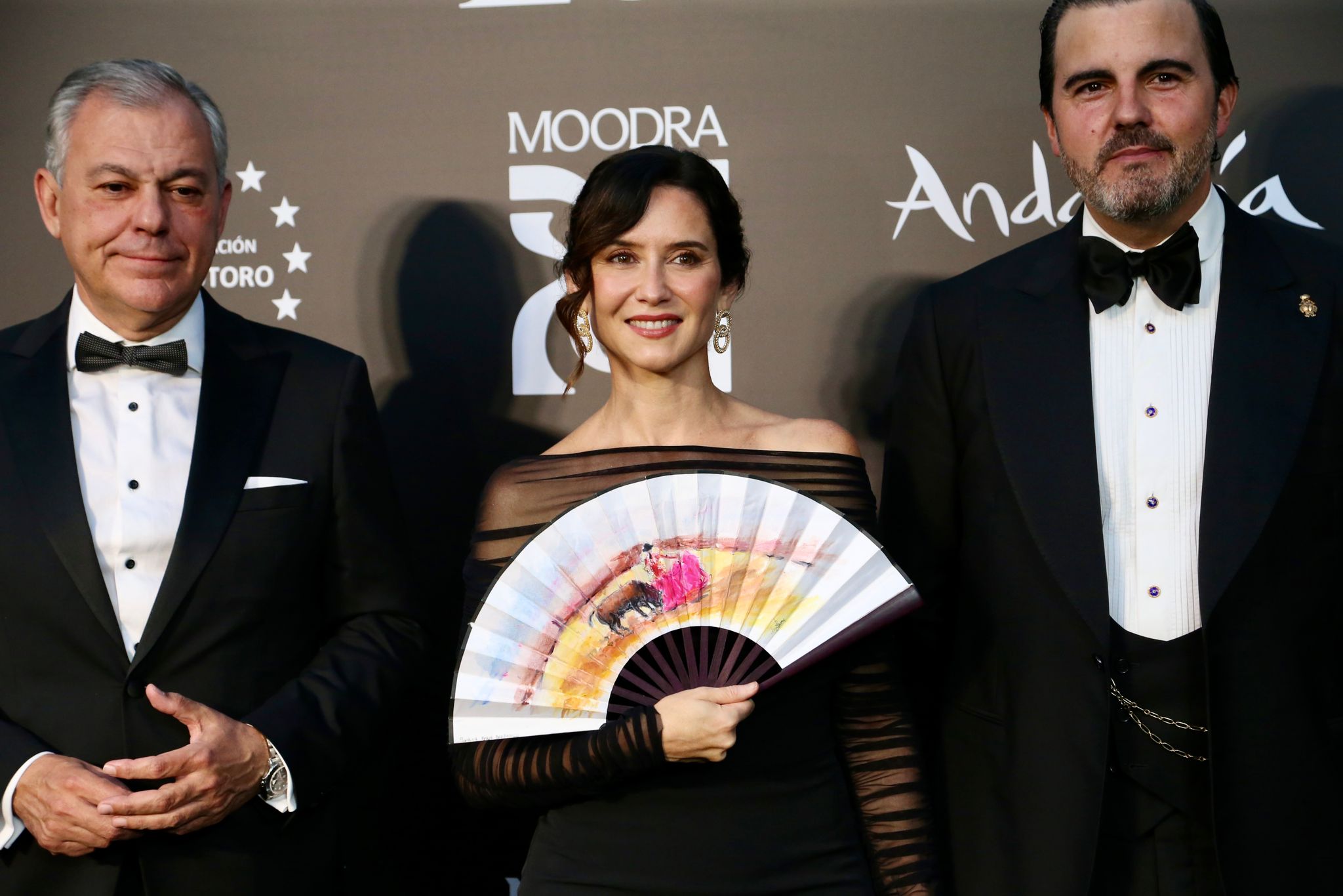 Isabel Díaz Ayuso con un abanico con motivos taurinos, junto al alcalde de la ciudad, José Luis Sanz y Mario Niebla del Toro