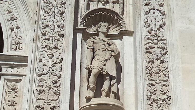 Escultura de Julio César flanqueando el arquillo del Ayuntamiento de Sevilla. Pieza historicista añadida en el siglo XIX durante la reforma de la fachada; la iconografía recuerda la tradición de la fundación romana de Híspalis. La autoría de las piezas se atribuye en la bibliografía local a Vicente Hernández Couquet