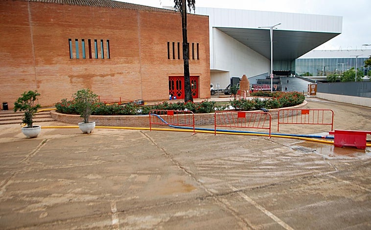 Imagen principal - Operarios trabajan en la inundación de Fibes 1 