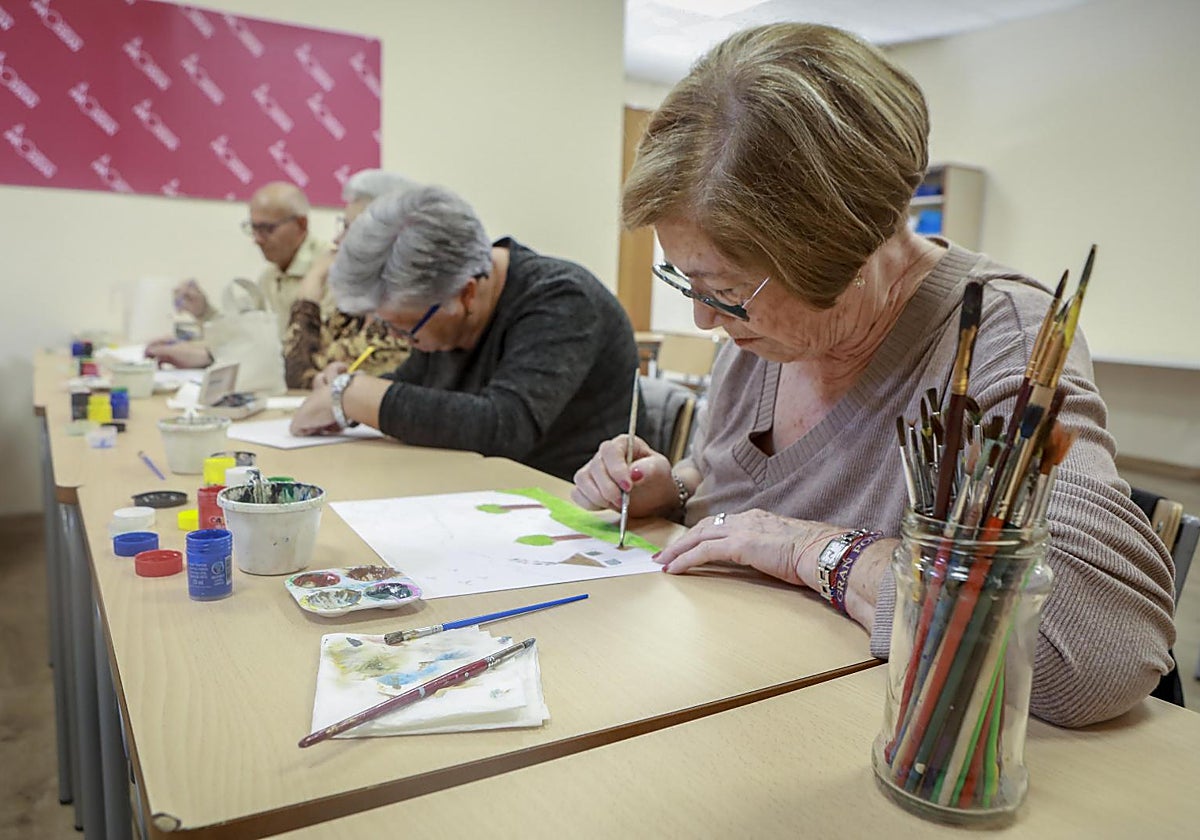 Julia, usuaria en la Fundación Prodean de Los Pajaritos, participa junto a sus compañeros en el taller de pintura