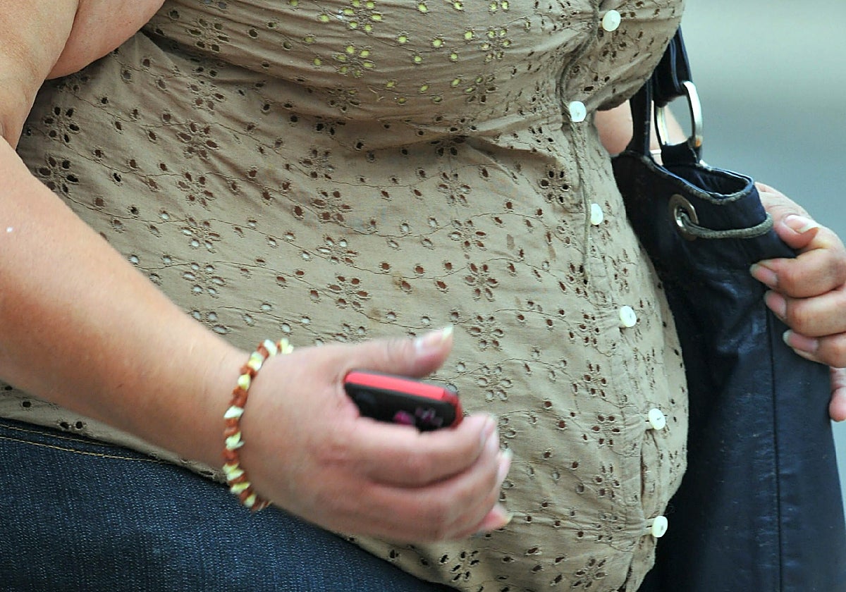 Una mujer con sobrepeso camina en una calle de México