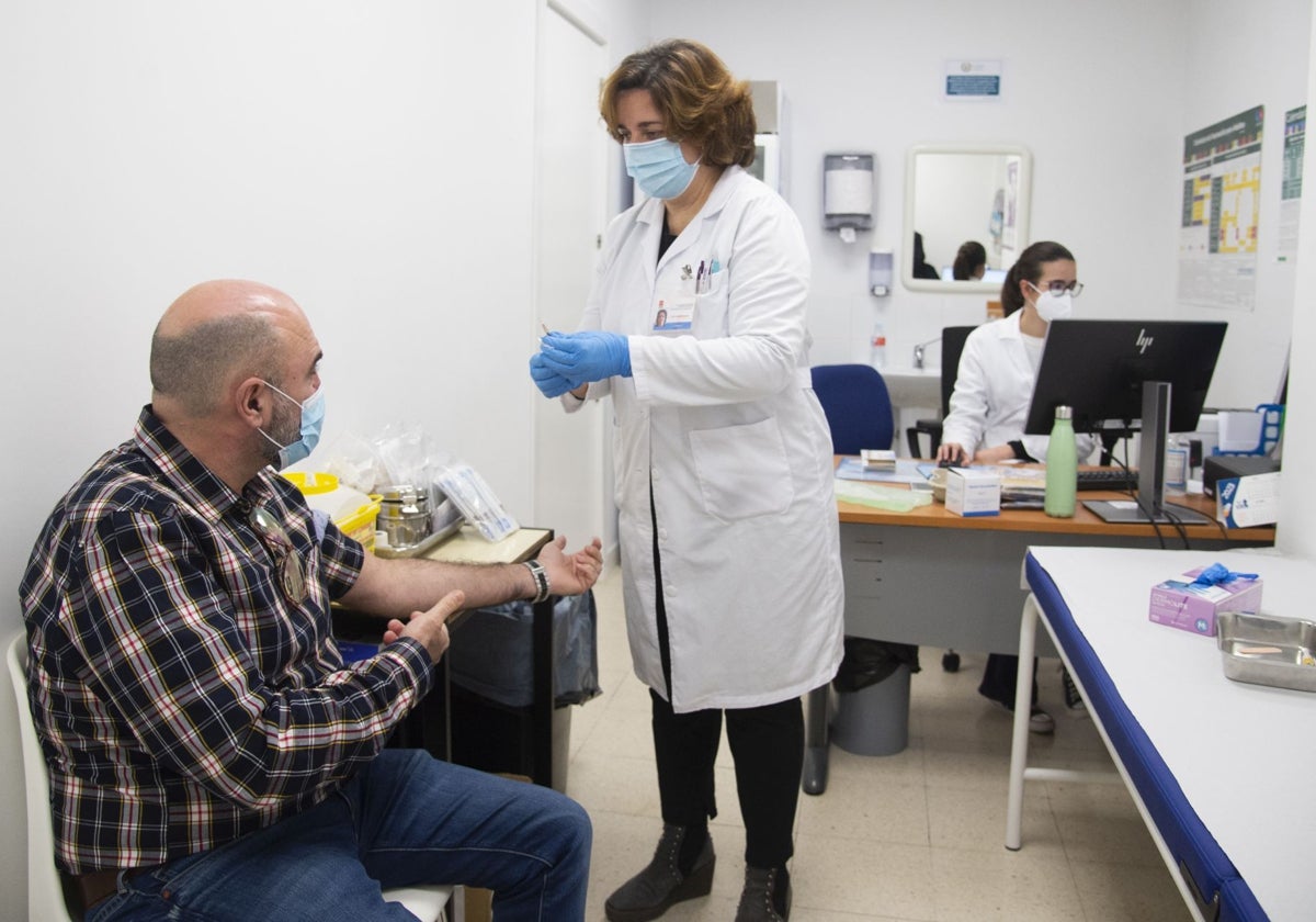 Una enfermera se prepara para vacunar a un paciente