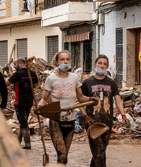 Imagen secundaria 2 - Arriba, el estado actual del barranco. Abajo, redes de ayuda en la casa de Andalucía (izquierda) y voluntarias limpiando (derecha)