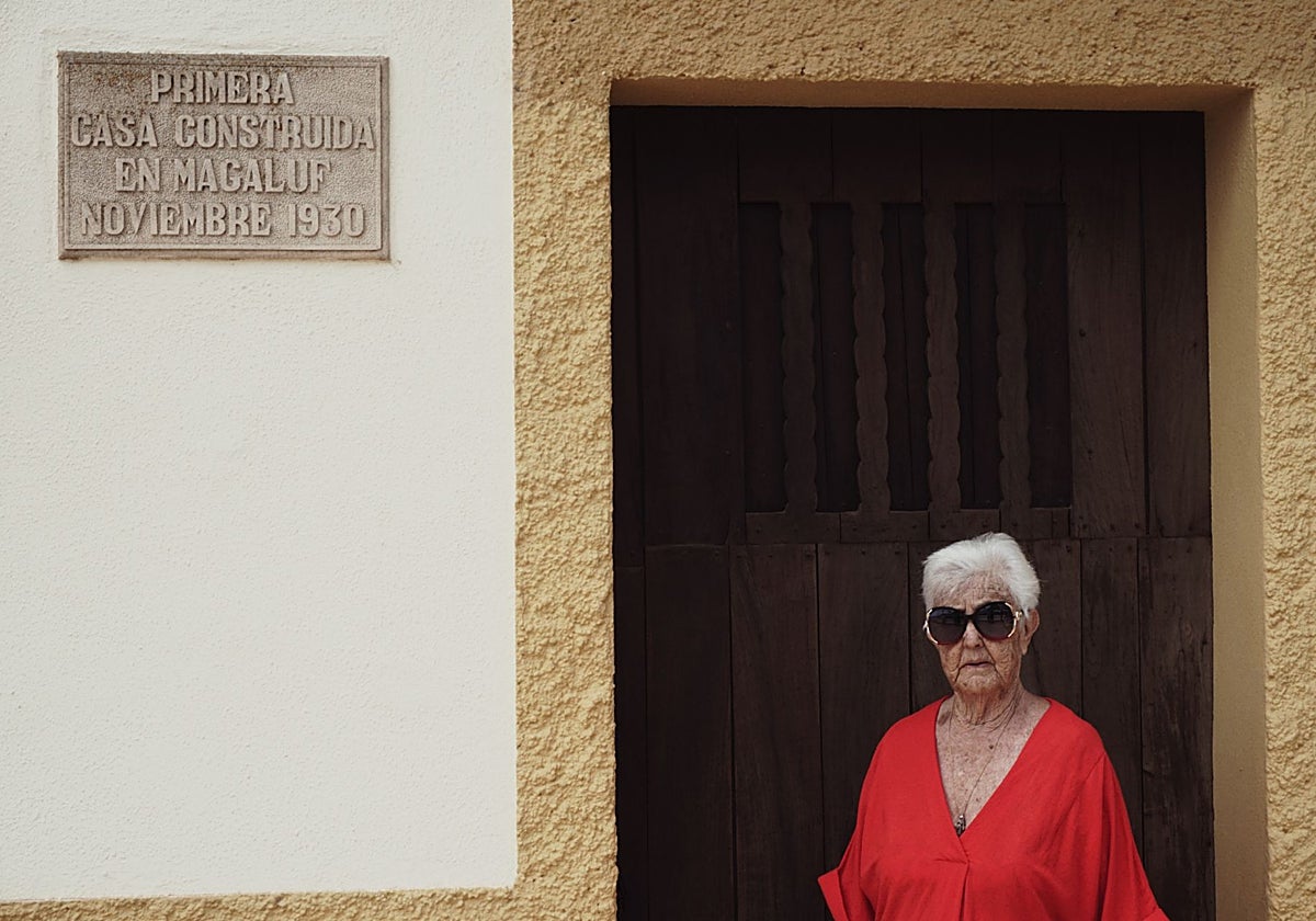 Catalina Feliu en la puerta de su vivienda, junto a la placa que constata que es la primera casa construida en Magaluf