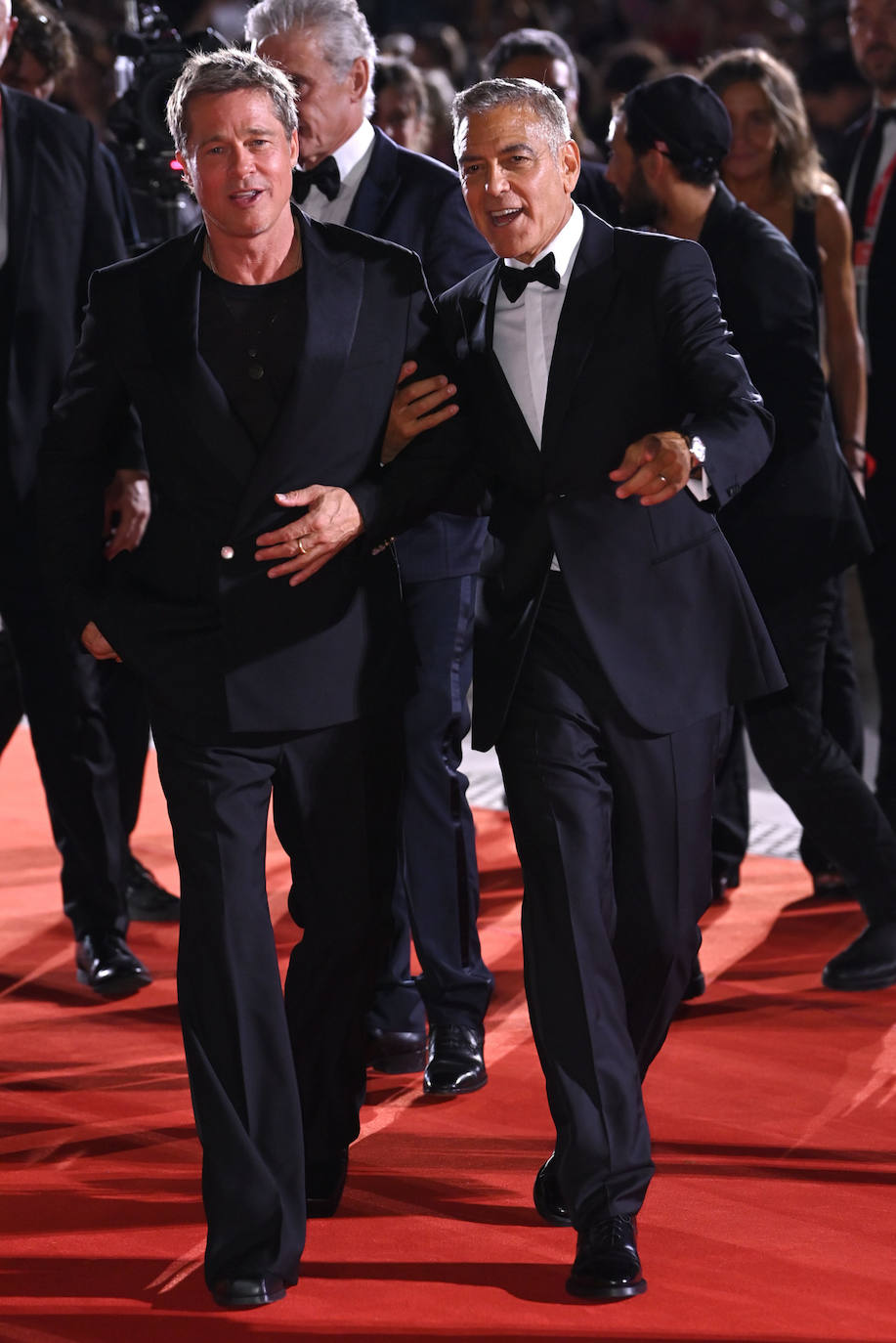Brad Pitt y George Clooney derrocharon buen humor y estilo en la alfombra roja del Festival de cine de Venecia. El primero optó por un traje más moderno de Louis Vuitton, el segundo por el esmoquin con pajarita. 