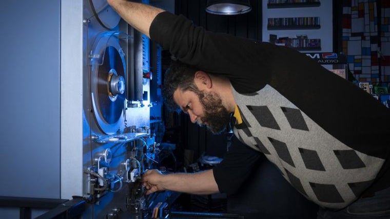 Luis González 'trasteando' con la máquina con la que hace las casetes, una Tapematic 2002 fabricada a finales de los noventa que encapsula la cinta ferromagnética en la cubierta de plástico