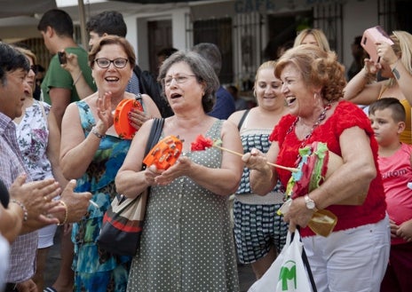 Imagen secundaria 1 - La gran fiesta de Nochevieja en la plaza de la Iglesia (arriba); Vecinas cantando villancicos (abajo izquierda) y uno d elos árboles de Navidad que decoran el municipio (abajo izquierda)