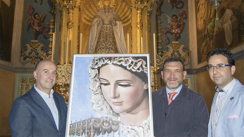 La Borriquita entrega a Los Negritos un cuadro  como recuerdo de la Coronación