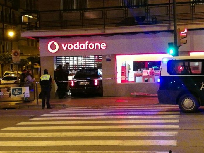 Empotran un vehículo en una tienda de Vodafone de Huelva y sufren un accidente mientras huyen de la Policía