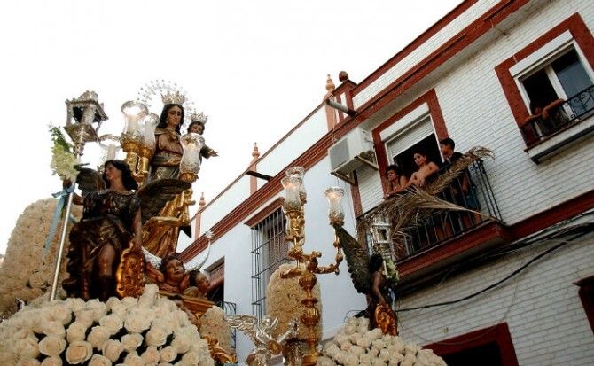 La procesión de María Auxiliadora reúne en La Palma a cientos de devotos de toda Andalucía