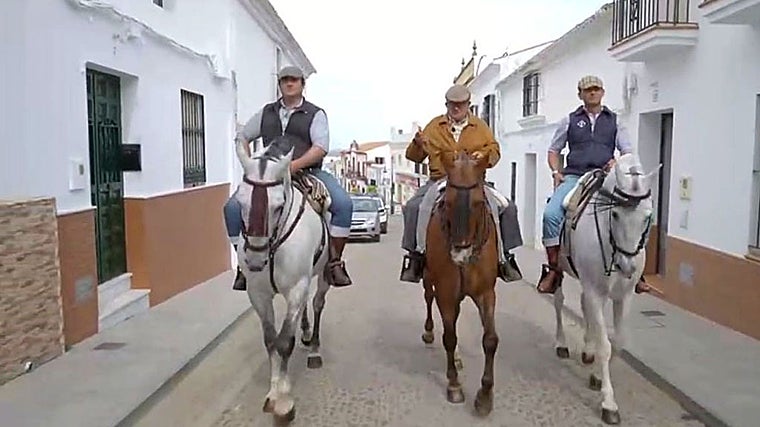 Vecinos de Puebla de Guzmán paseando a caballo por una calle del pueblo