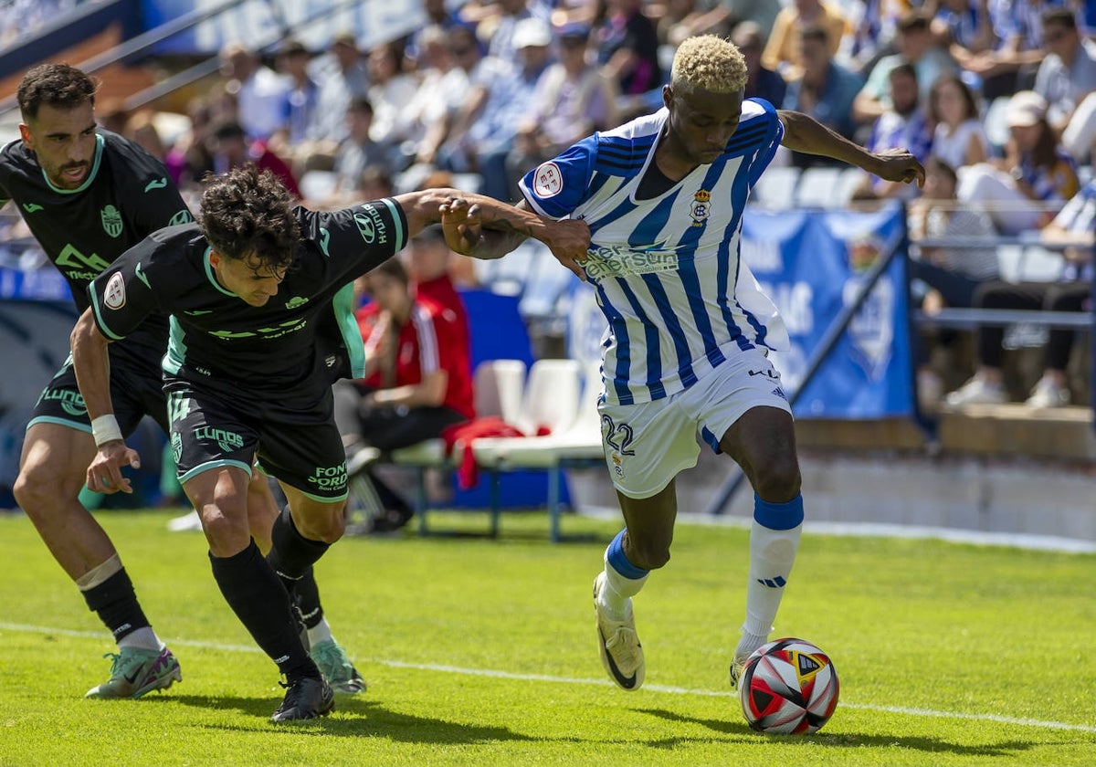 Rahim presionado por dos adversarios durante el Recreativo-Atlético Baleares