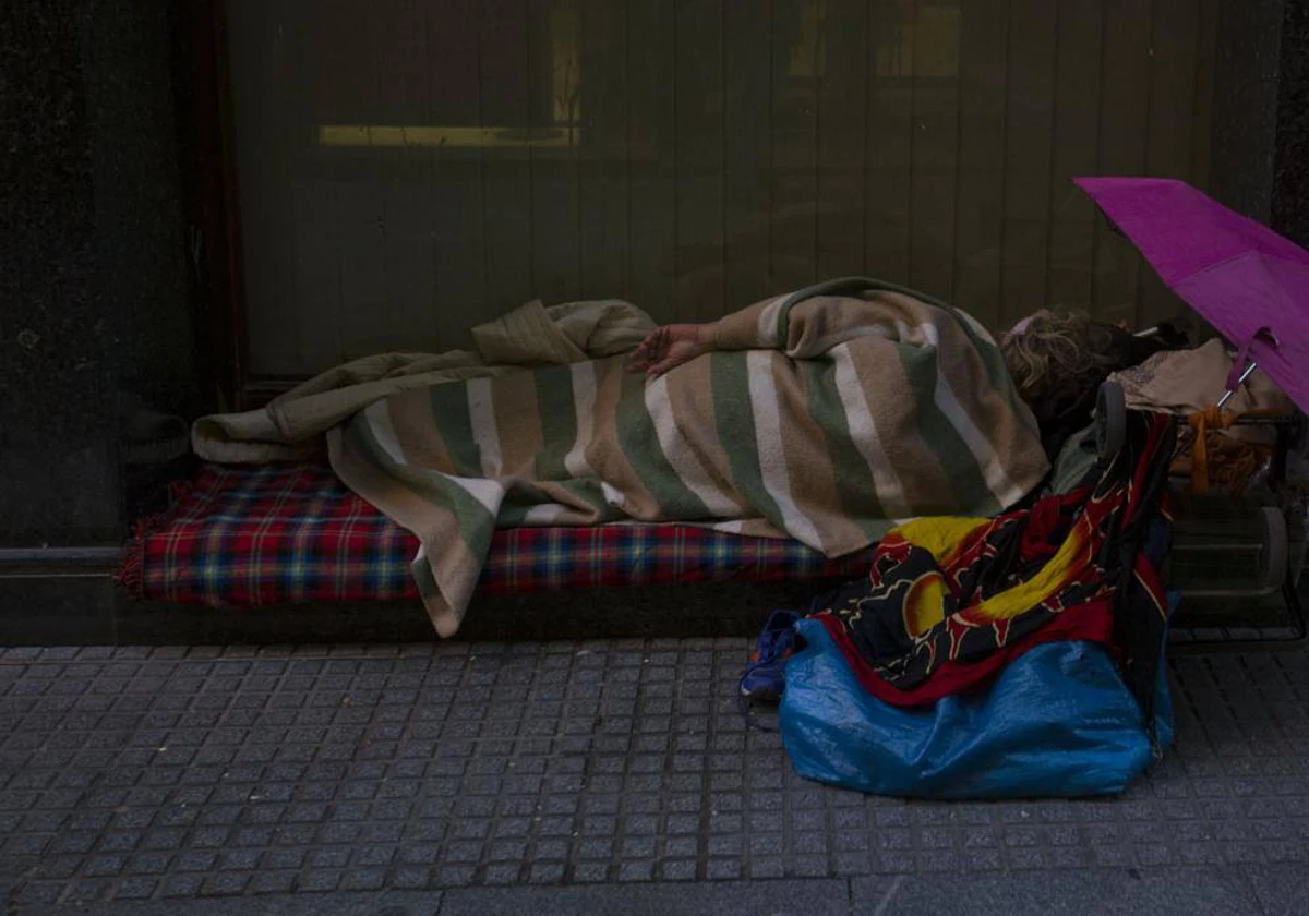 Una persona sin hogar durmiendo en una calle de Cádiz.