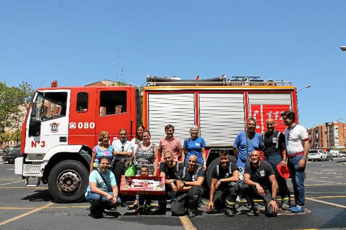 El pequeño con un grupo de bomberos de Huelva