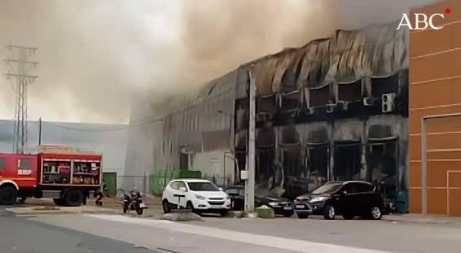 Espectacular incendio en una empresa de transporte de alimentación refrigerada en Sevilla