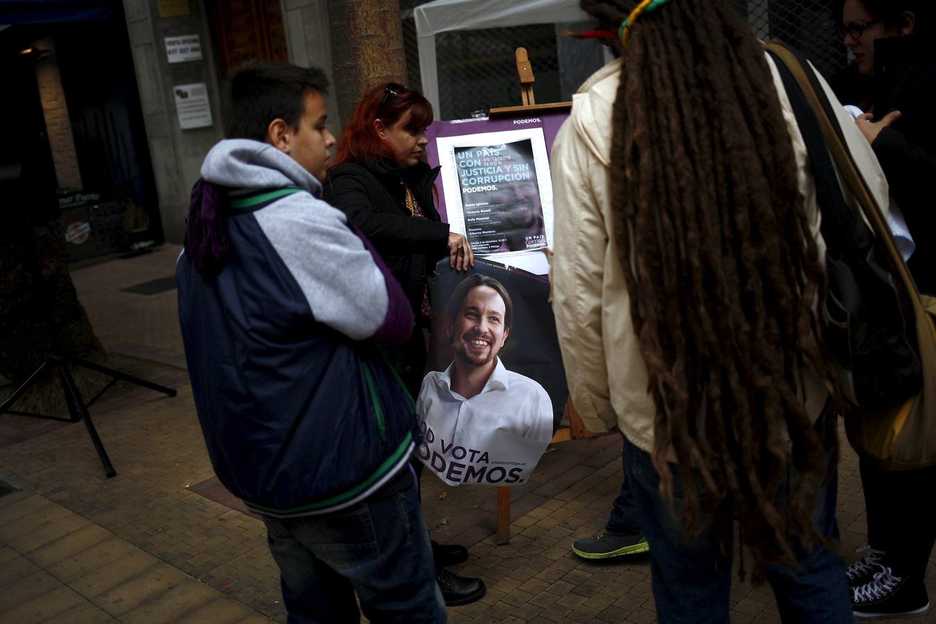 Ciudadanos de Málaga sujetan el cartel de Podemos. 