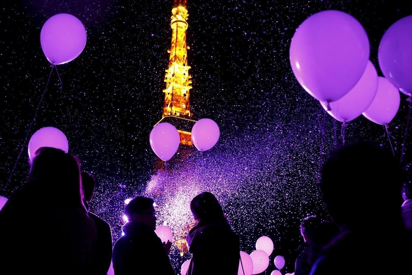 Un grupo de personas celebra el Año Nuevo con globos frente a la Torre de Tokio, en Tokio, Japón. 