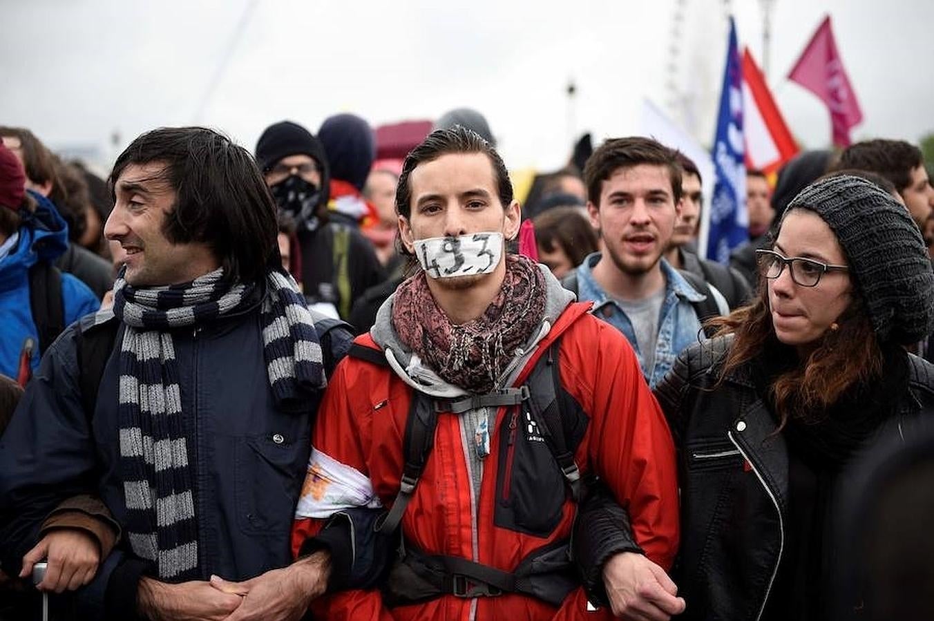 Un joven se tapa la boca con una pegatina que hace alusión al polémico artículo que permite sacar adelante la reforma laboral sin que esta sea votada en el Parlamento. 