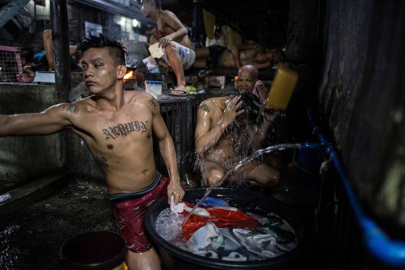 Los presos de Quezon City se asean en un baño abarrotado. 