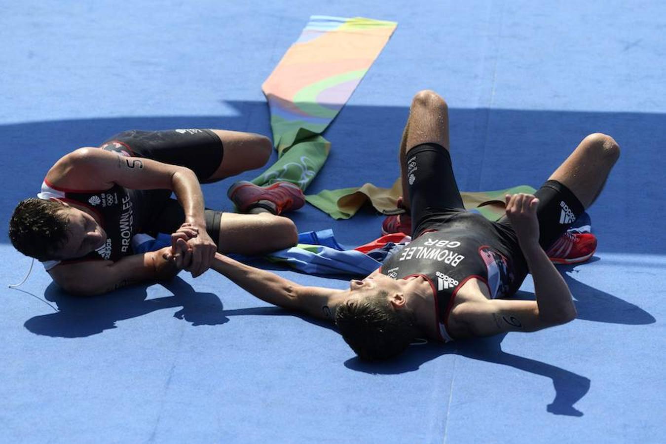 Triunfo compartido. Los británicos Alistair y Jonathan Brownlee han conseguido oro y plata en el Triatlón. Un éxito doble que estos dos hermanos han celebrado en el suelo, extenuados por la prueba