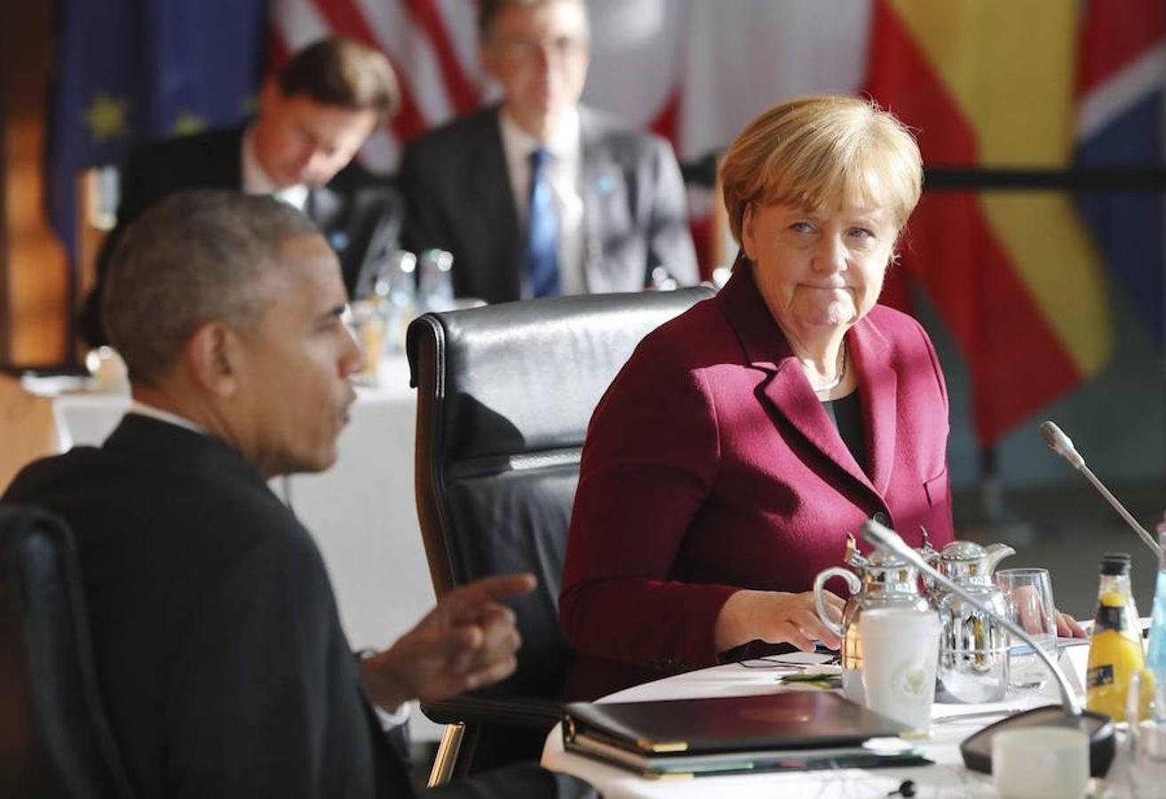 Angela Merkel escucha la intervención de Barack Obama